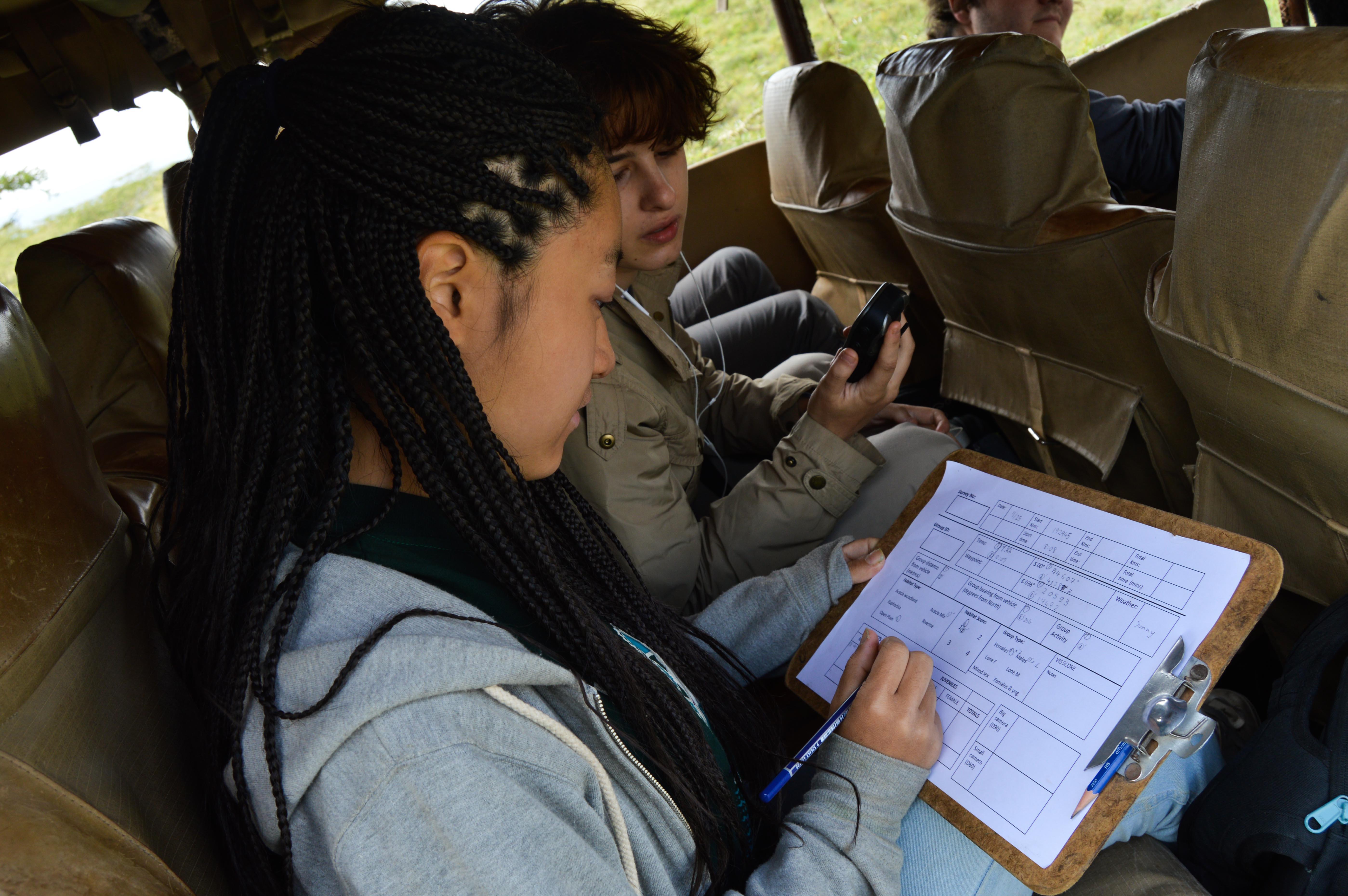 Projects Abroad volunteers fill in data about wildlife during volunteer opportunities for teenagers in Kenya Teenagers fill in data about wildlife during conservation volunteer work in Kenya